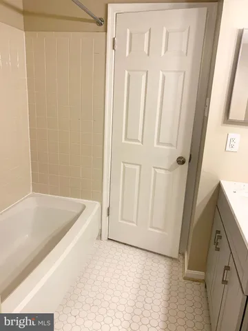 a bathroom with a bathtub and a sink