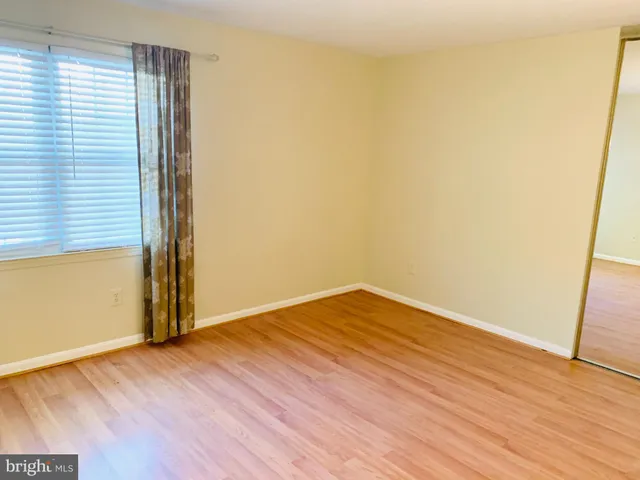 an empty room with wooden floor