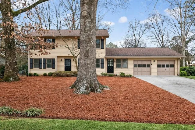 a front view of a house with a garden