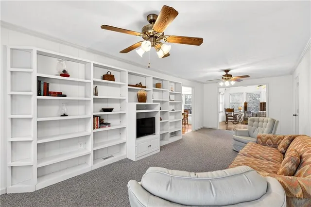 a view of a house with a big yard and large tree