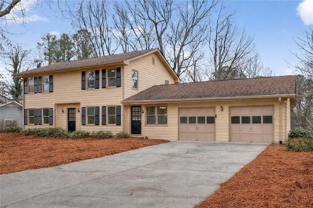 a view of a hallway with wooden floor and stairs