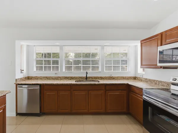 a kitchen with a sink stove and cabinets
