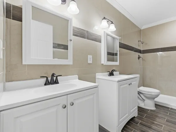 a bathroom with a sink toilet and mirror