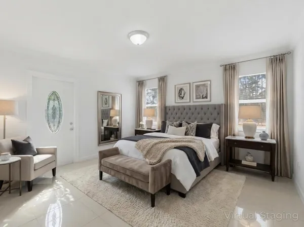 a spacious bedroom with a bed and a couch