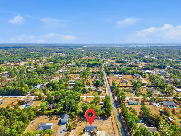 an aerial view of a house with a yard and fountain