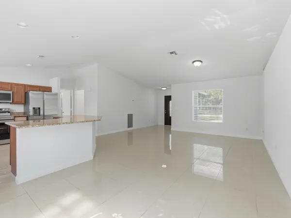 a view of kitchen with microwave and white cabinets