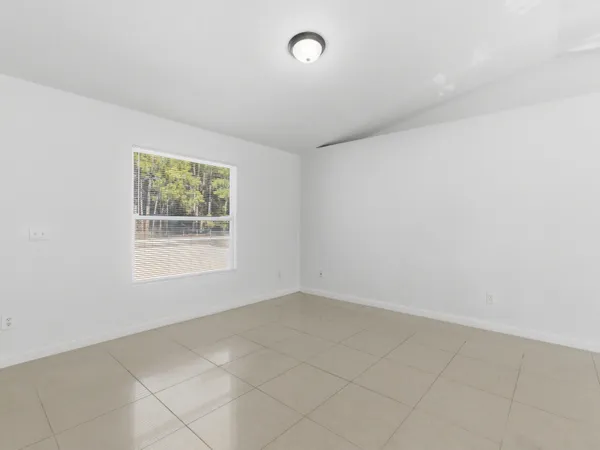 an empty room with a empty space and windows