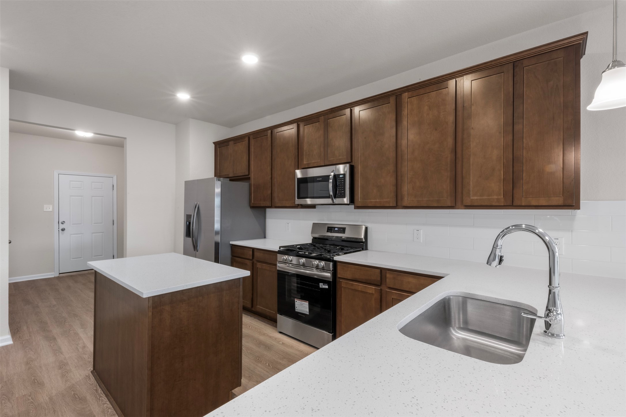 10249 Badger Run Lane Magnolia, TX 77354 - Photo 12 of 36 a kitchen with stainless steel appliances wooden cabinets a sink and a stove