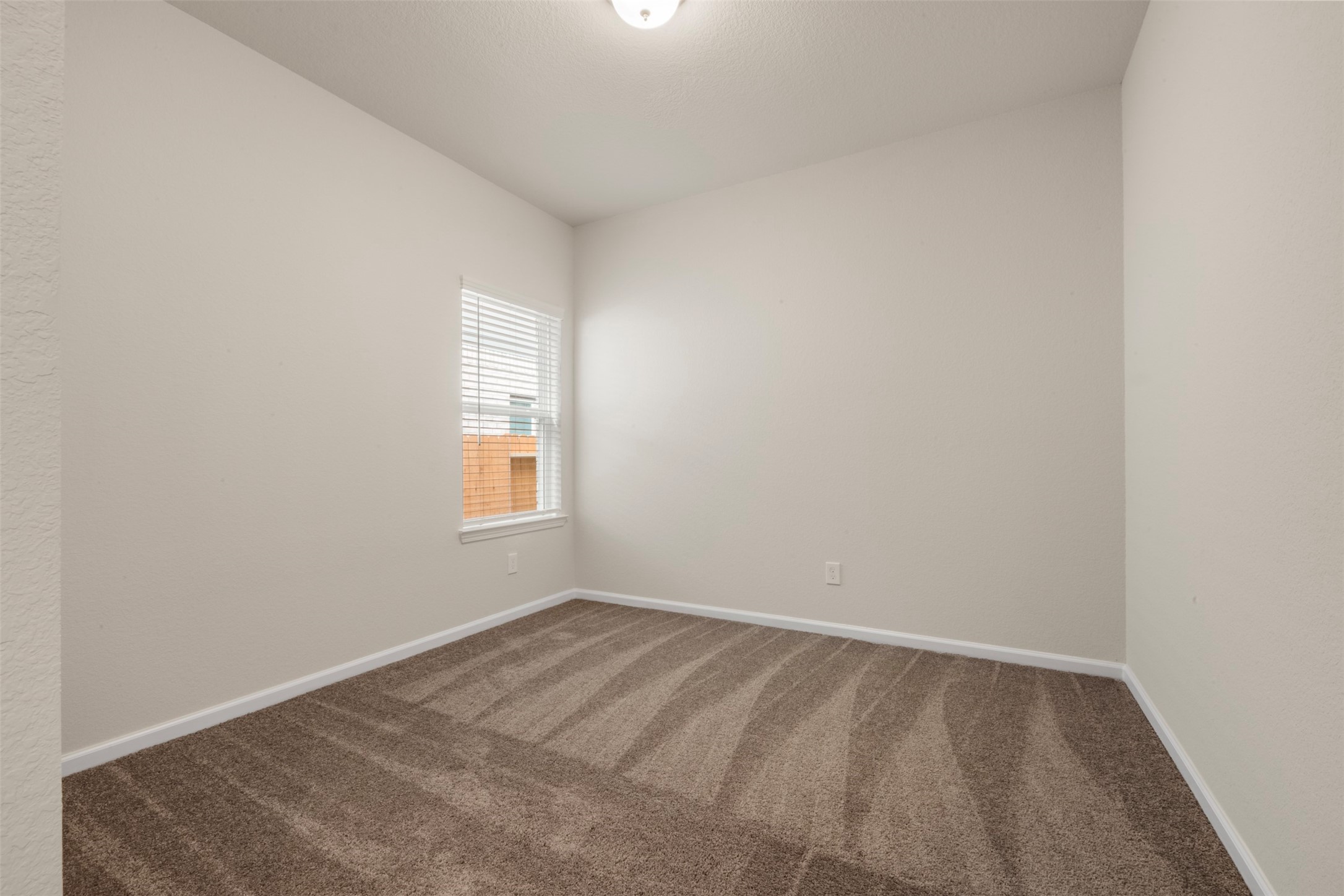 10249 Badger Run Lane Magnolia, TX 77354 - Photo 22 of 36 a view of an empty room with a window