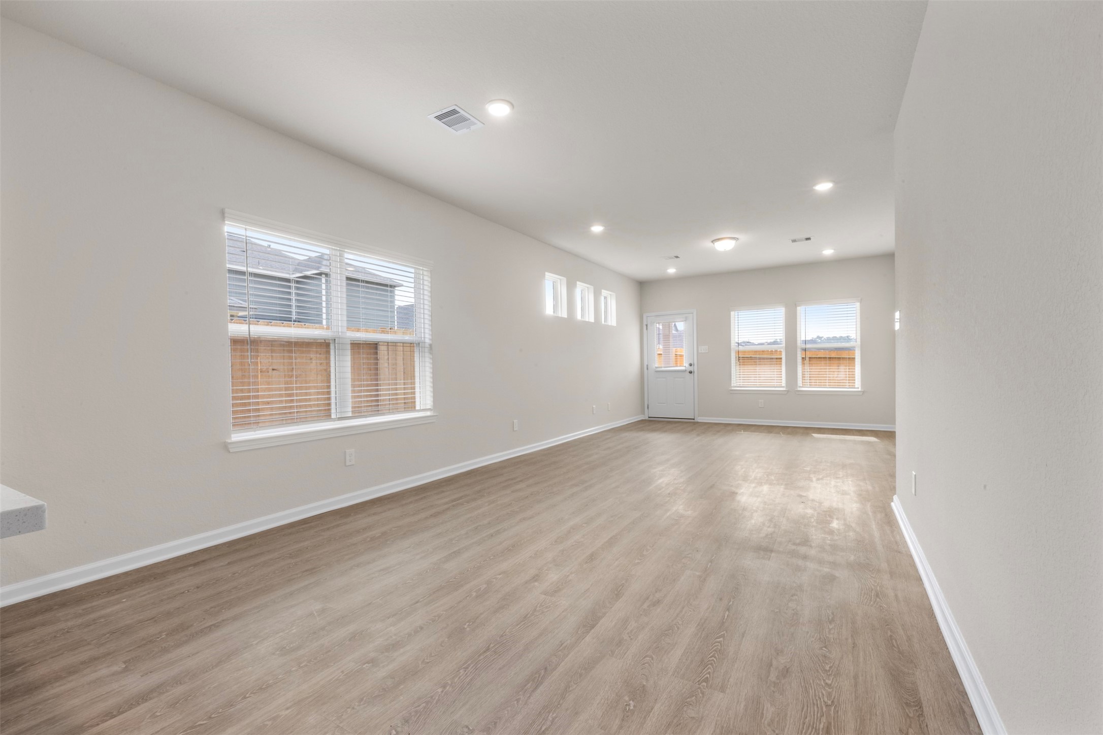 10249 Badger Run Lane Magnolia, TX 77354 - Photo 5 of 36 a view of an empty room with wooden floor and windows
