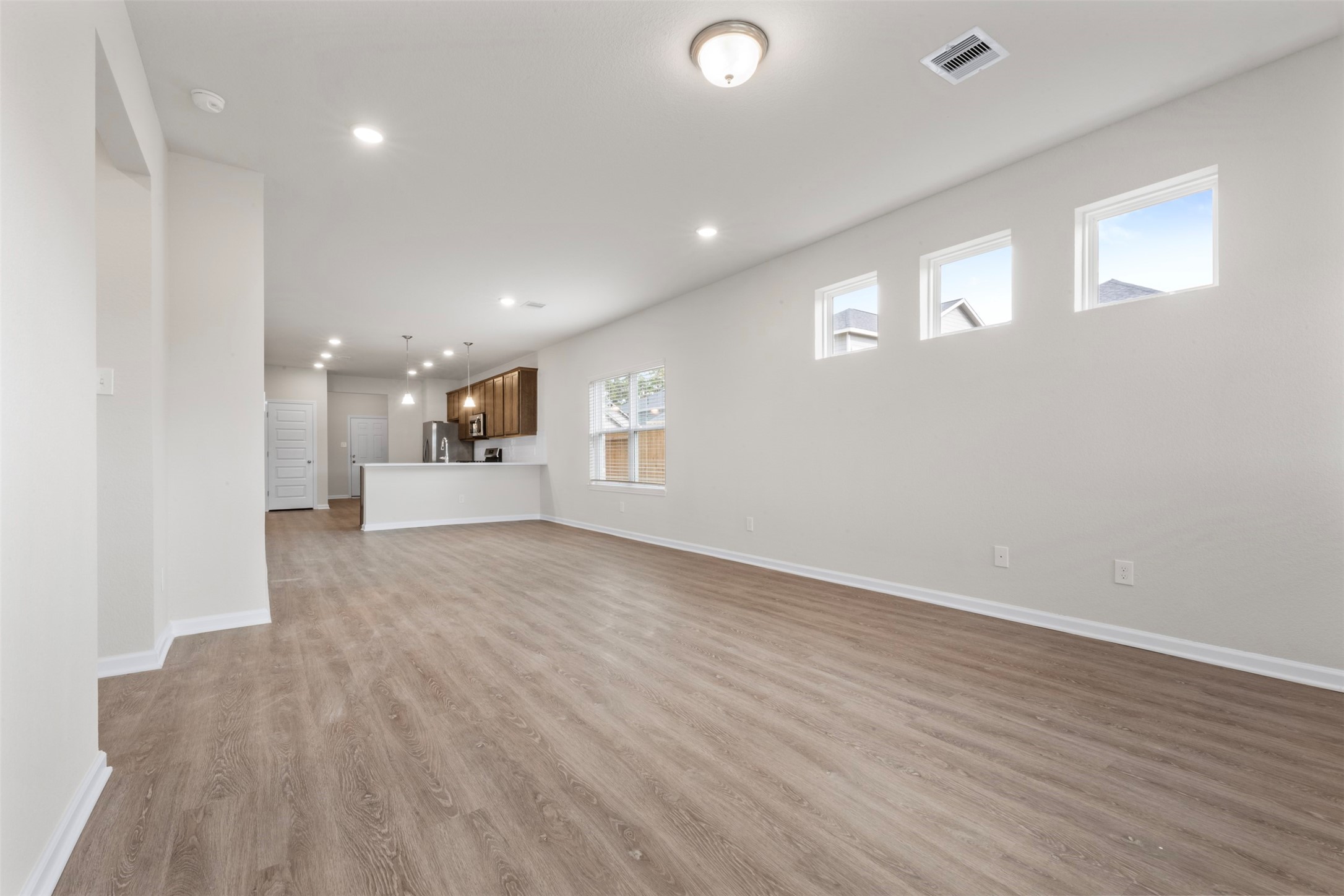 10249 Badger Run Lane Magnolia, TX 77354 - Photo 7 of 36 a view of a big room with wooden floor and windows