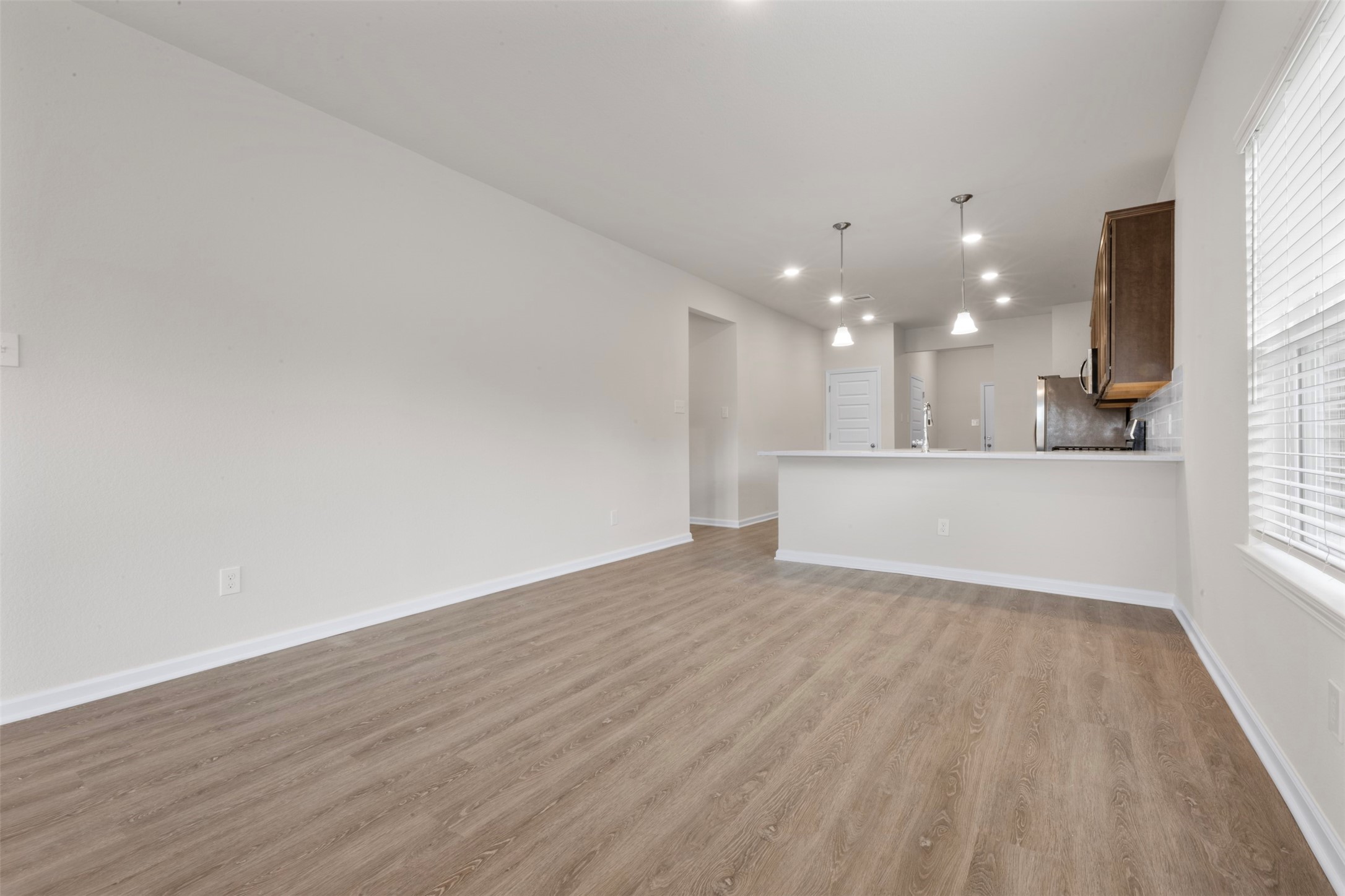 10249 Badger Run Lane Magnolia, TX 77354 - Photo 9 of 36 a view of a kitchen with wooden floor and a window