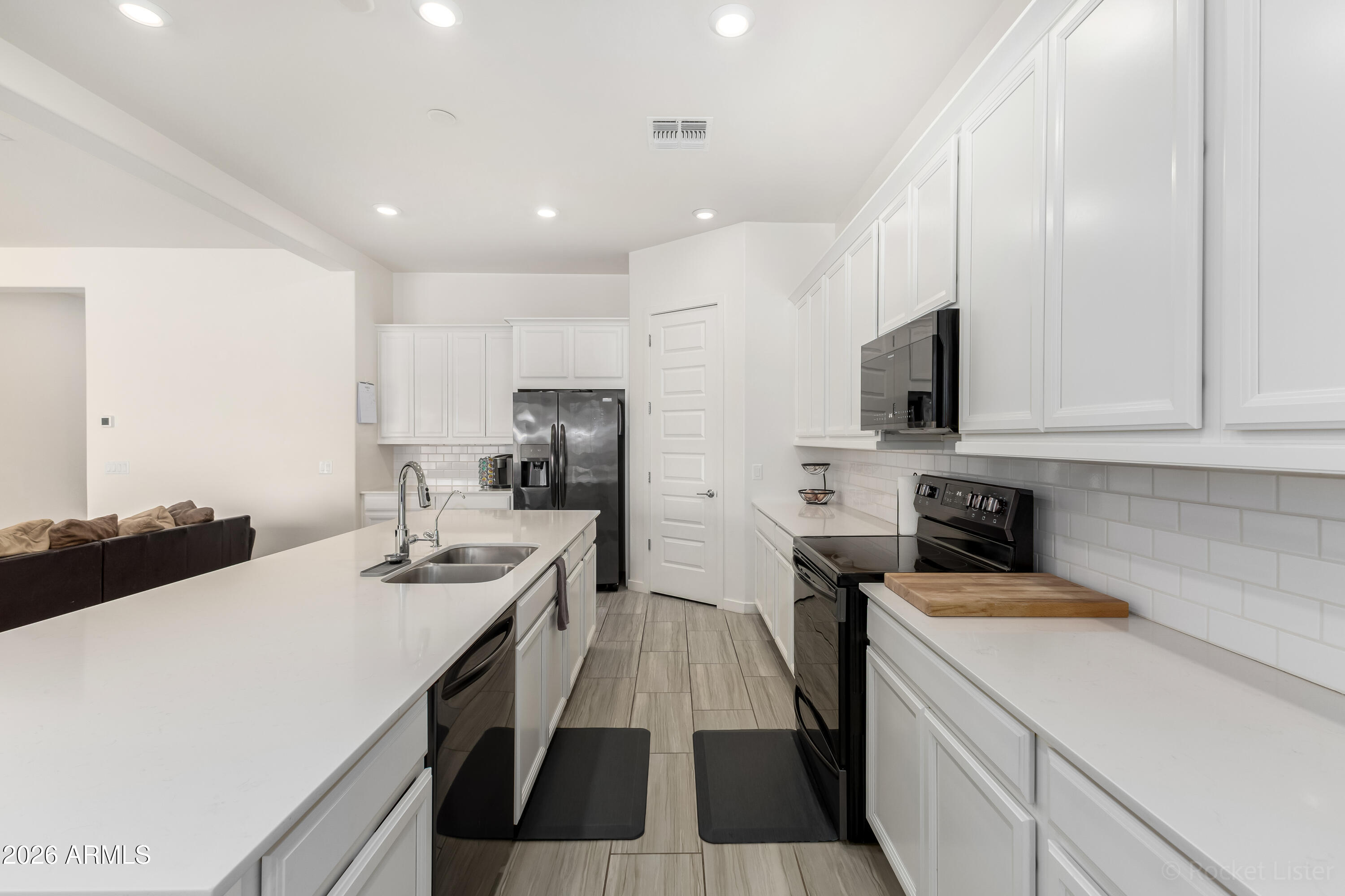 23929 North 166th Lane Surprise, AZ 85387 - Photo 9 of 23 a kitchen that has a sink a stove and refrigerator