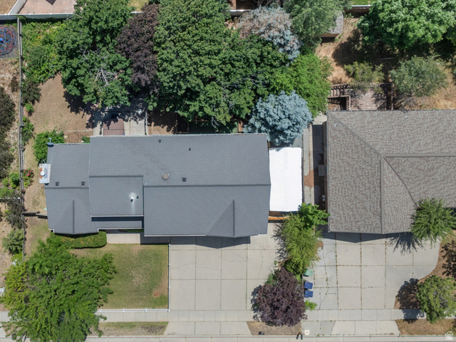 1726 Wasatch Boulevard Sandy, UT 84092 - Photo 33 of 38 Expansive property featuring a large gray-roofed residence, a significant paved driveway, and mature landscaping