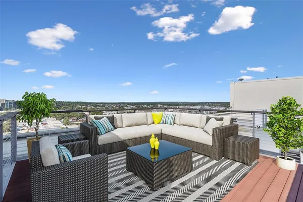 a living room with furniture a chandelier and a rug