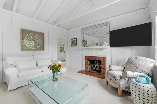 a kitchen with stainless steel appliances granite countertop a stove a sink dishwasher a dining table and chairs with wooden floor