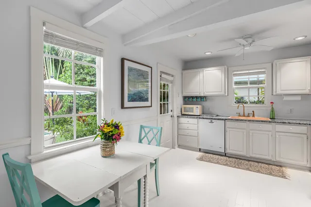 a dining room with furniture and a window