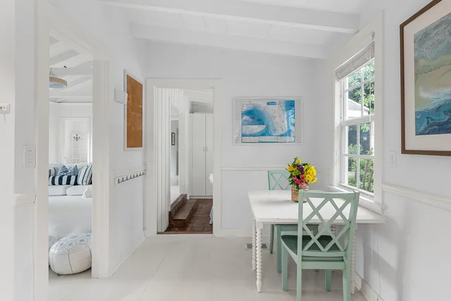 a bedroom with a bed a mirror and a large window