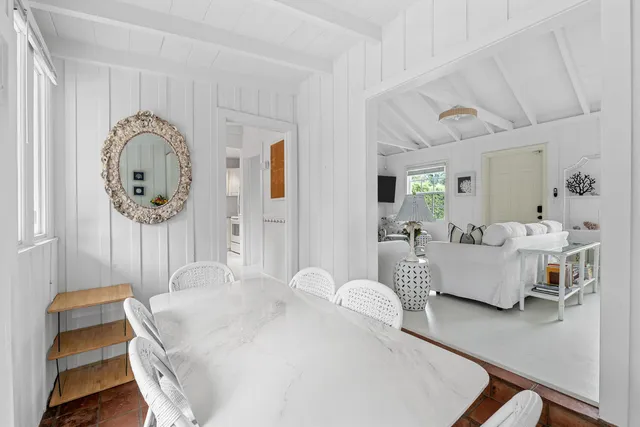 a bedroom with a large bed and paintings on the wall