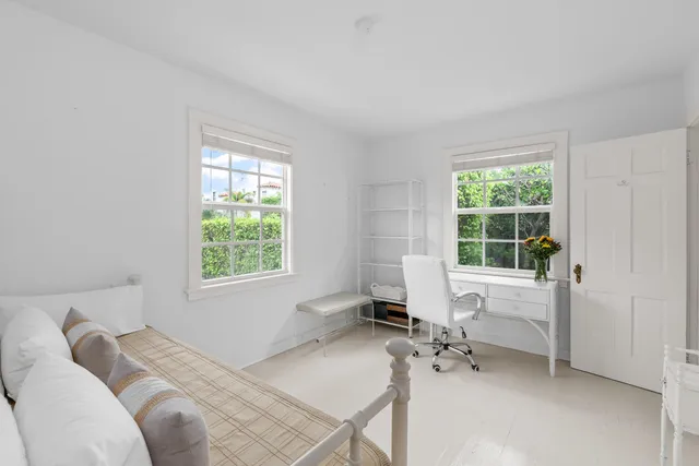 a view of a patio with chairs under an umbrella