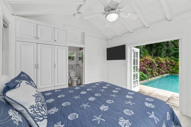 a view of a patio with table and chairs potted plants and palm tree