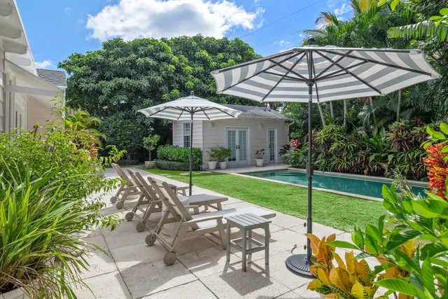 a view of a house with backyard sitting area and garden