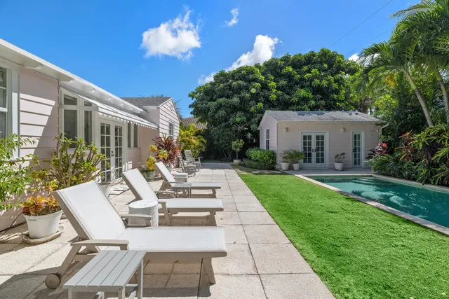 a view of a patio with couches table and chairs and potted plants