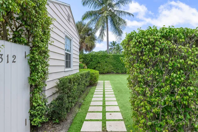 a living room with furniture a fireplace and a chandelier