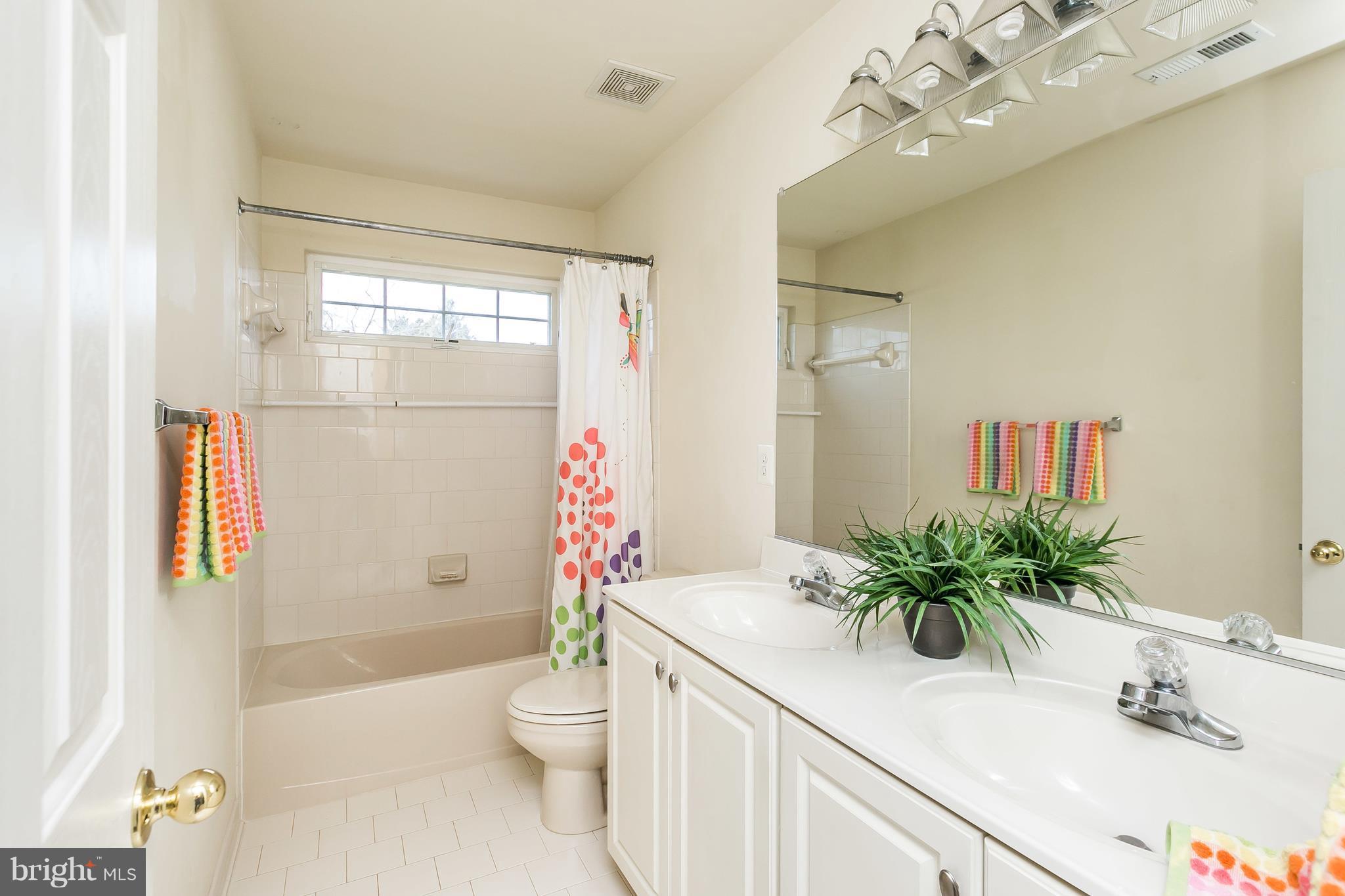 1324 North Rolling Road Baltimore, MD 21228 - Photo 21 of 30 a bathroom with a sink a toilet and shower