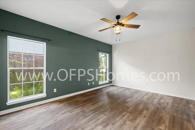 a view of a ceiling fan and wooden floor
