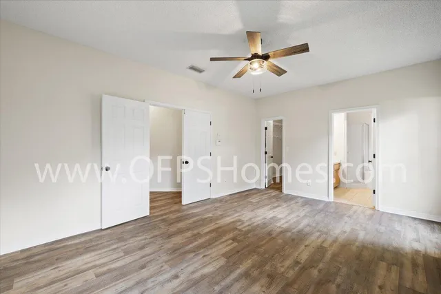 a view of a big room with wooden floor and windows in a room