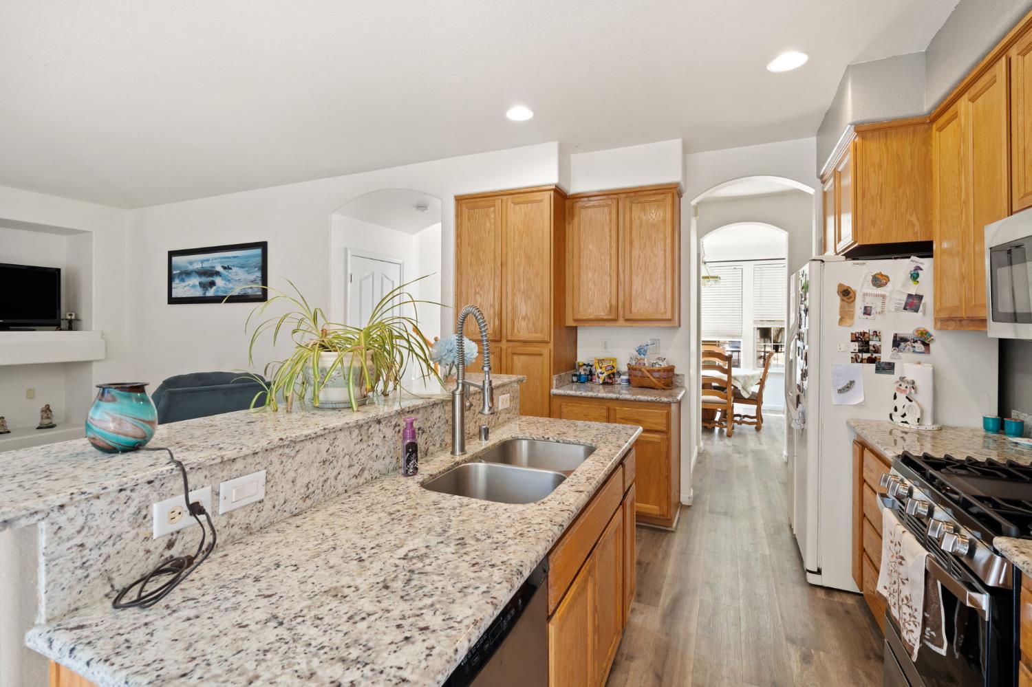 46 Bascom Court Sacramento, CA 95835 - Photo 13 of 34 a kitchen with stainless steel appliances granite countertop a sink a stove and a wooden floors