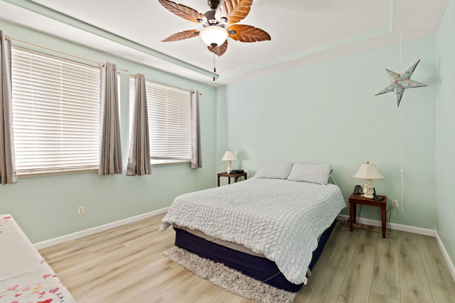 46 Bascom Court Sacramento, CA 95835 - Photo 15 of 34 a bedroom with a bed and a chandelier