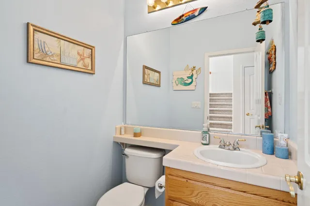 a bathroom with a toilet a sink and a mirror