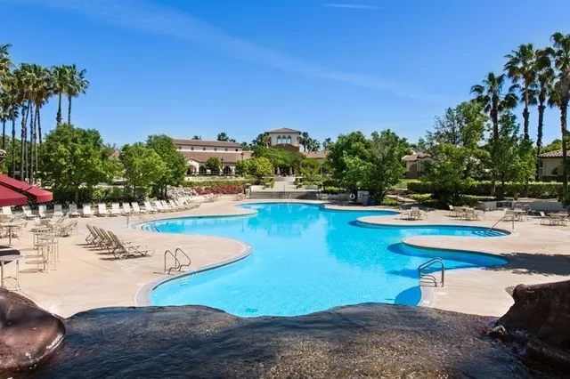a view of a swimming pool with an outdoor space and seating area