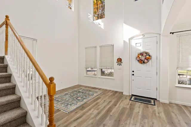 a view of an entryway with wooden floor