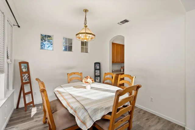 a dining room with furniture and wooden floor