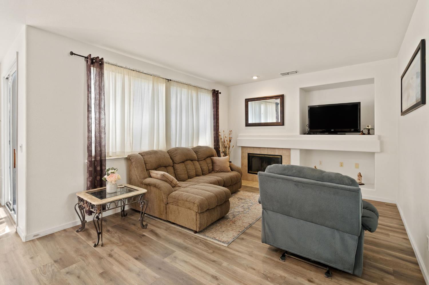 46 Bascom Court Sacramento, CA 95835 - Photo 9 of 34 a living room with furniture and a flat screen tv