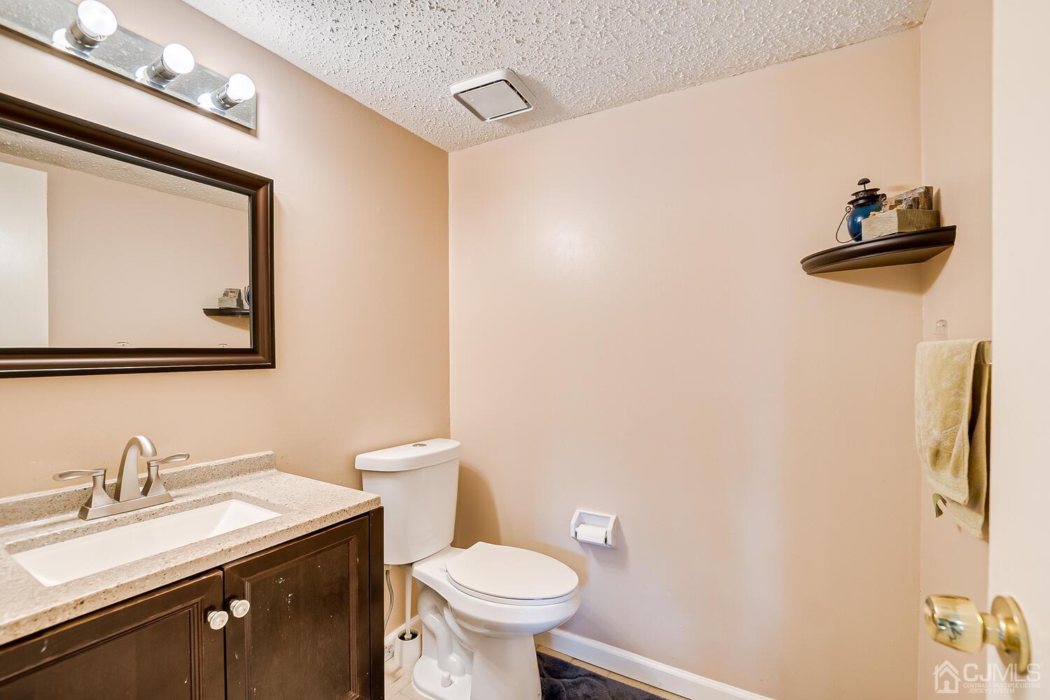 564 Westgate Drive Edison, NJ 08820 - Photo 14 of 37 a bathroom with a toilet sink and mirror
