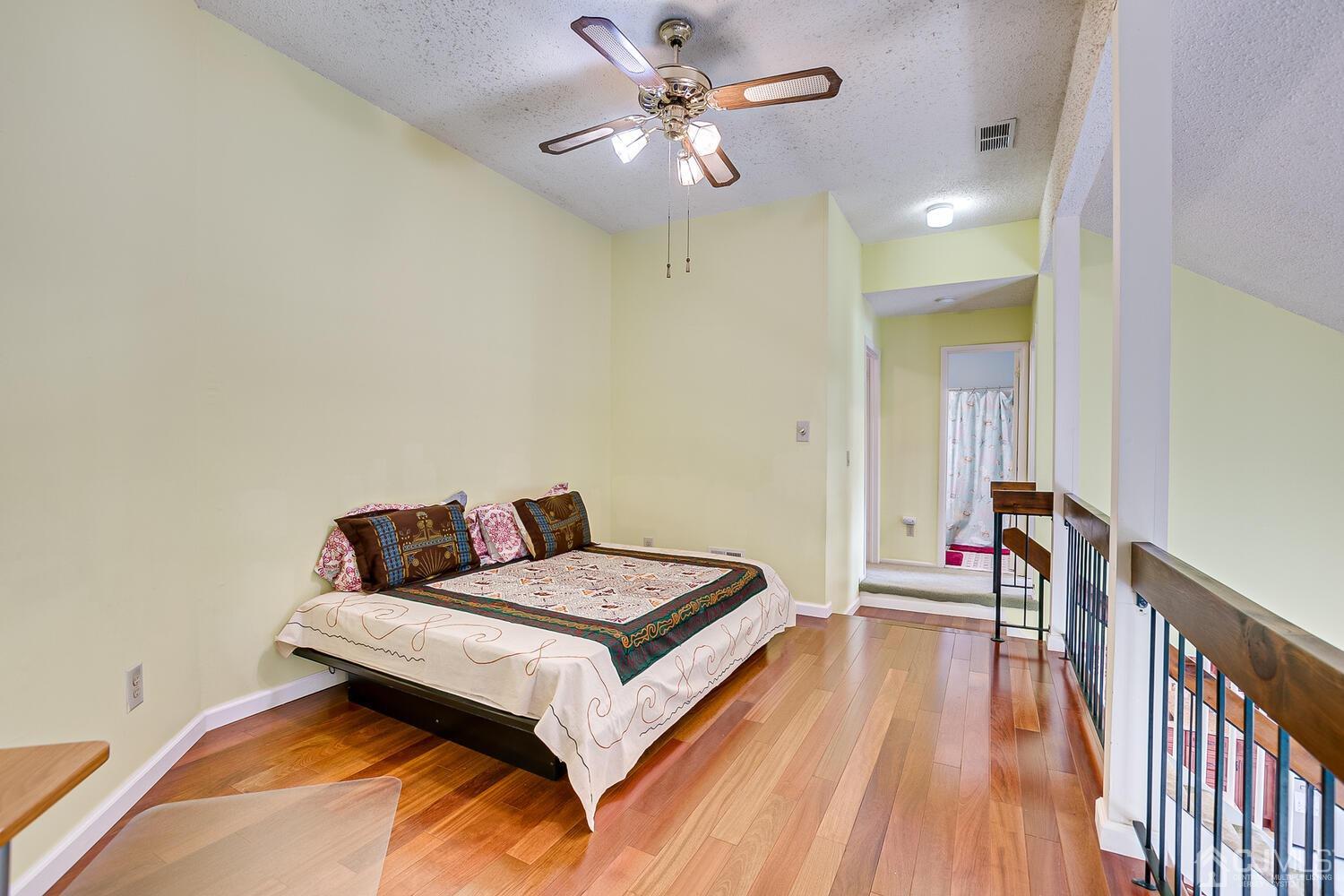 564 Westgate Drive Edison, NJ 08820 - Photo 15 of 37 a bedroom with a bed and a chandelier