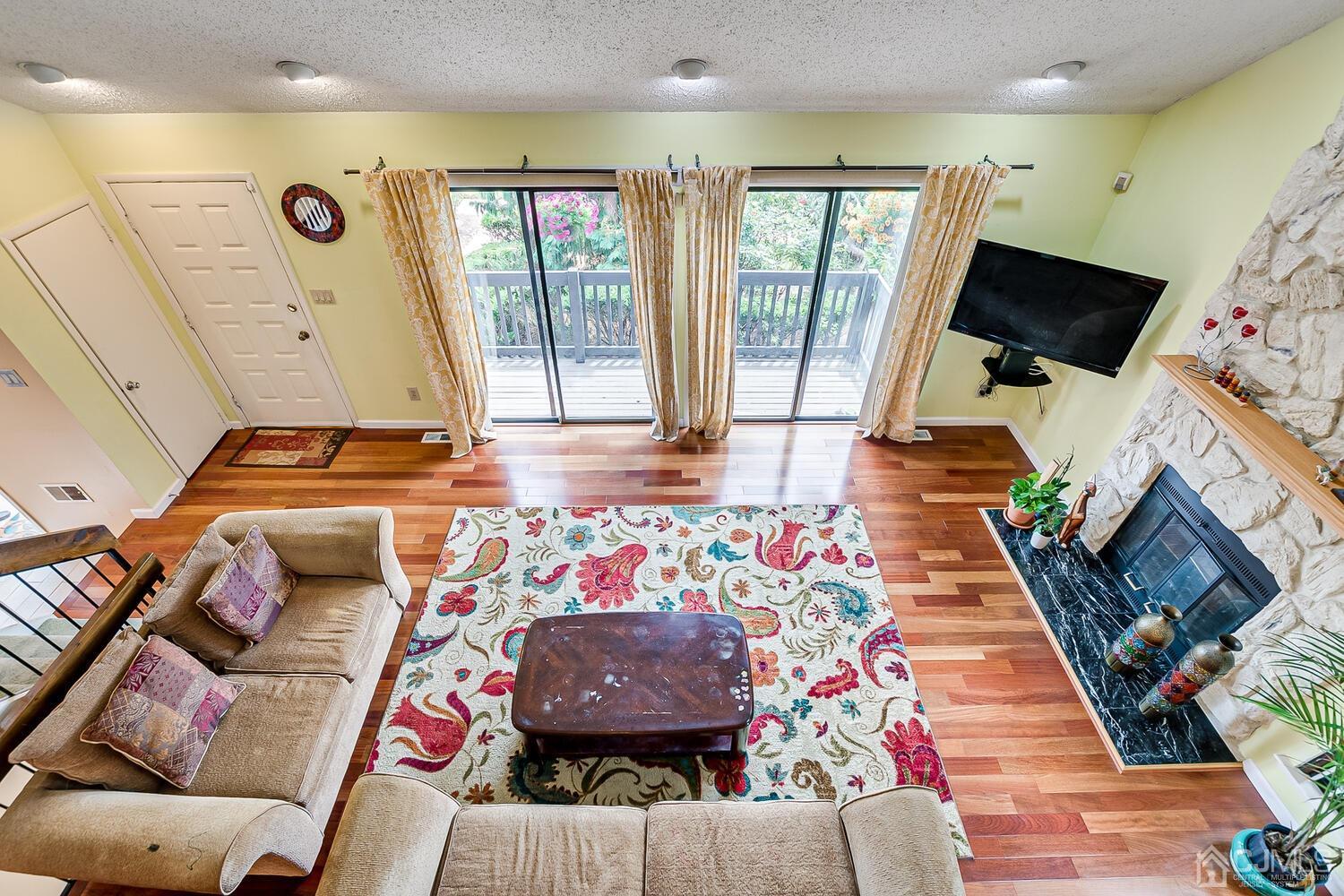 564 Westgate Drive Edison, NJ 08820 - Photo 16 of 37 a living room with furniture and a flat screen tv