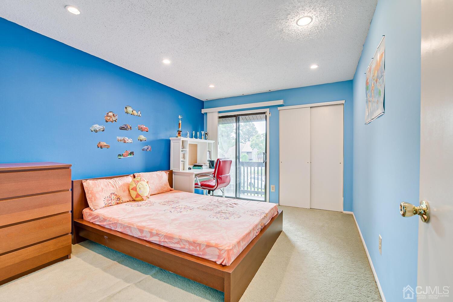 564 Westgate Drive Edison, NJ 08820 - Photo 23 of 37 a bedroom with a large bed and a chandelier