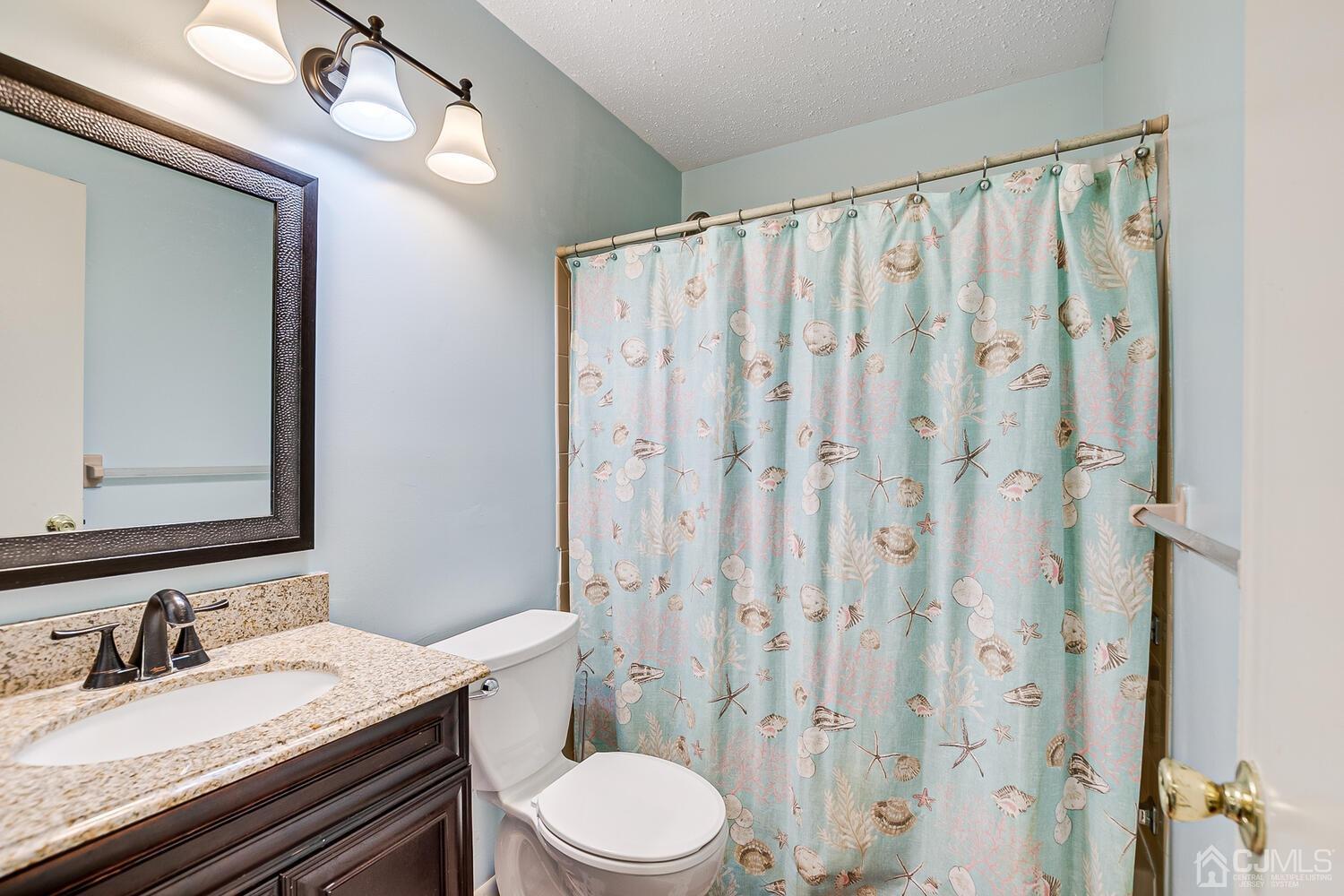 564 Westgate Drive Edison, NJ 08820 - Photo 25 of 37 a bathroom with a granite countertop sink toilet and shower
