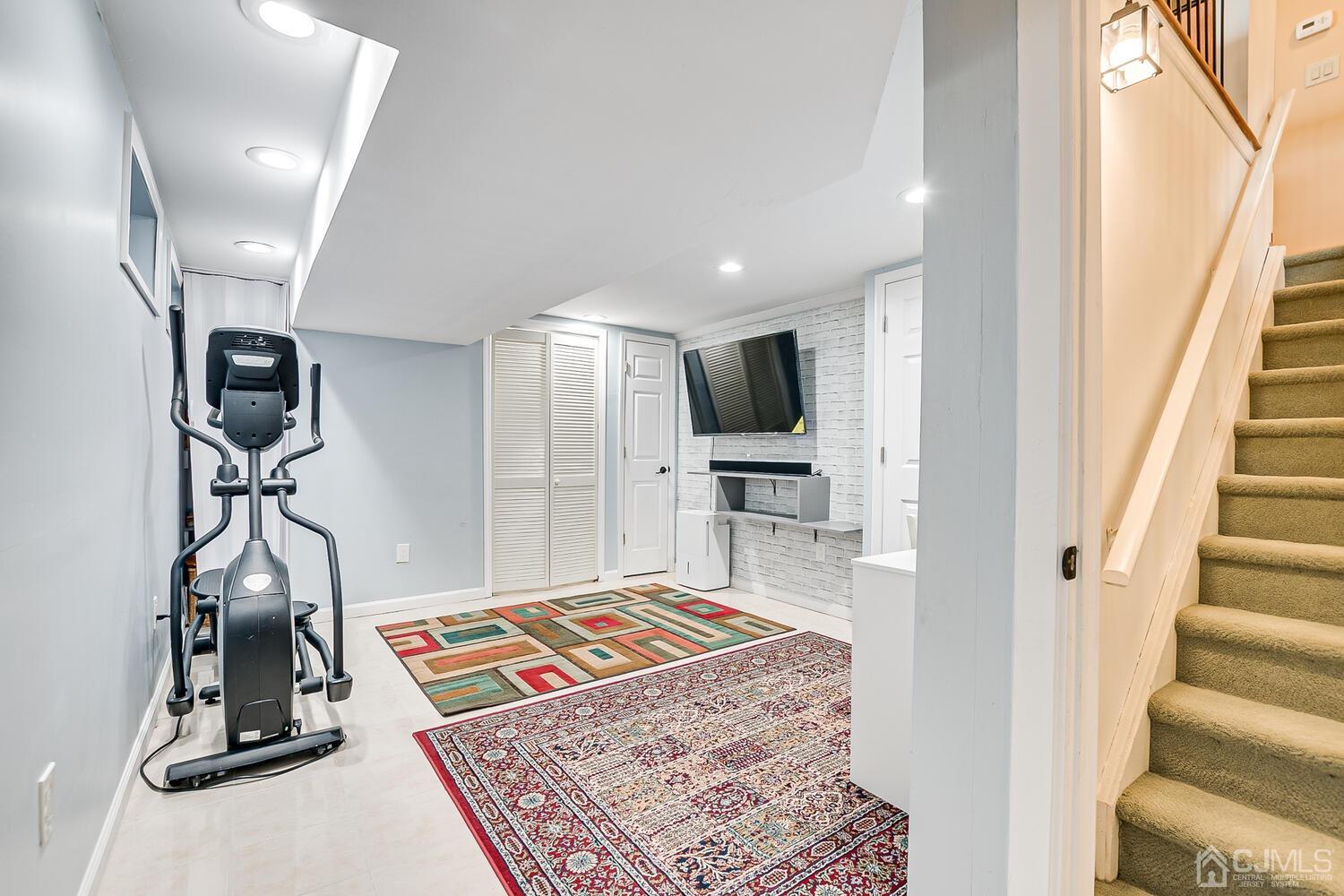 564 Westgate Drive Edison, NJ 08820 - Photo 26 of 37 a living room with a rug and a flat screen tv