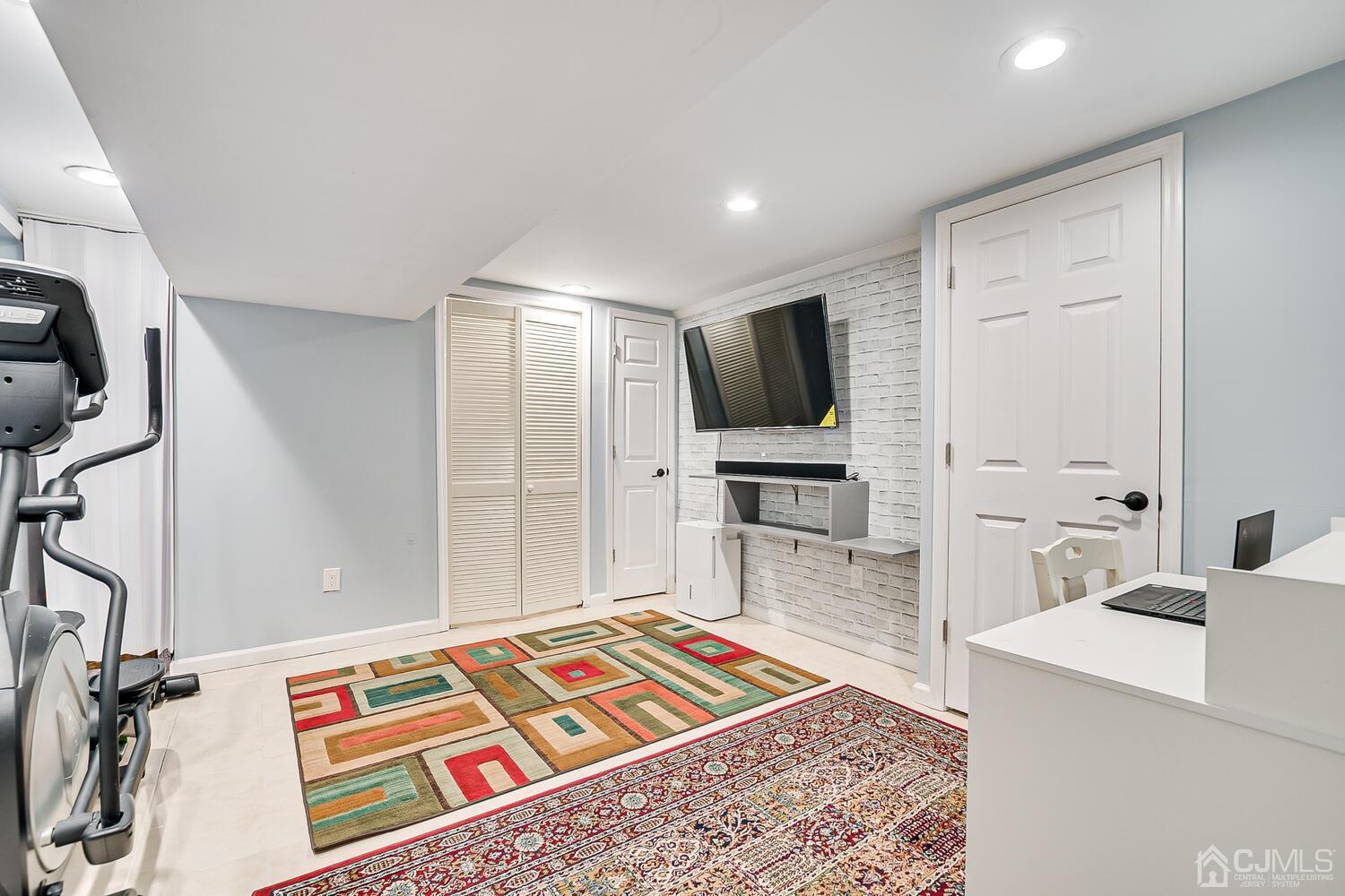 564 Westgate Drive Edison, NJ 08820 - Photo 29 of 37 a living room with furniture and a flat screen tv