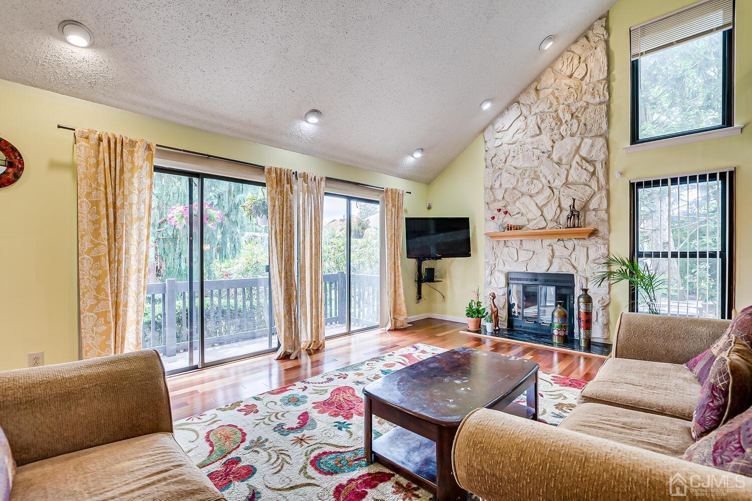 564 Westgate Drive Edison, NJ 08820 - Photo 6 of 37 a living room with furniture fireplace and large windows