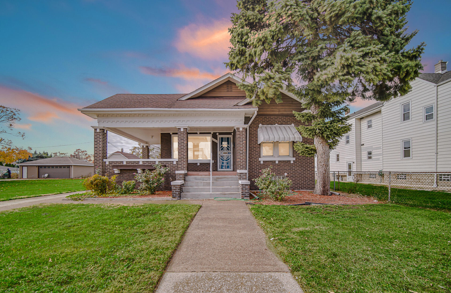 a front view of a house with a yard table and chairs