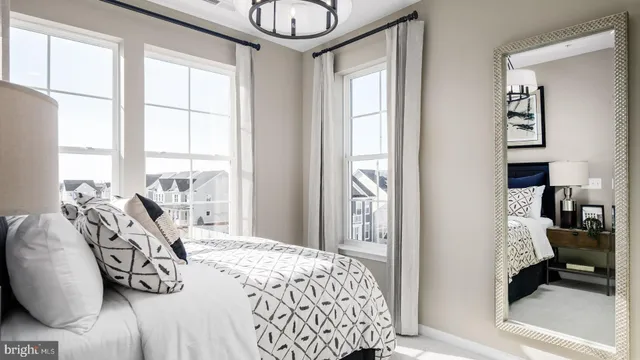 a bedroom with a bed and glass windows