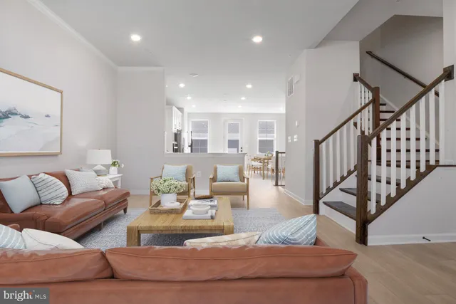 a living room with furniture and stairs