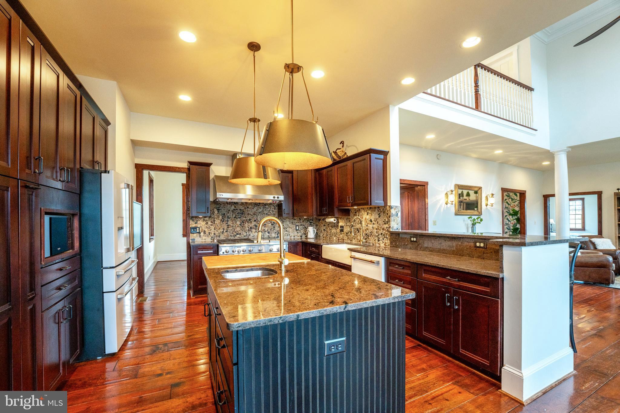 15718 Old Waterford Road Waterford, VA 20197 - Photo 26 of 81 a kitchen with stainless steel appliances granite countertop a sink a stove and a wooden floors
